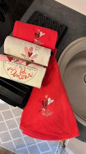 three red towels sitting on top of a counter at Gîte Verrière Du Château BURRUS in Sainte-Croix-aux-Mines