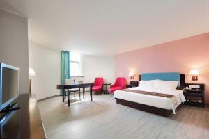 Voodi või voodid majutusasutuse Foshan Guanxin Hotel toas