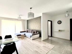 a living room with a couch and a table at Nature View Family Apartment in Braşov