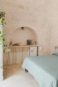 Ένα ή περισσότερα κρεβάτια σε δωμάτιο στο Nostos Trulli