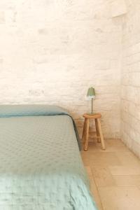 Postel nebo postele na pokoji v ubytování Nostos Trulli
