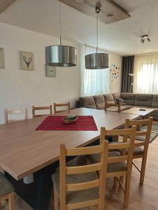 a dining room with a wooden table and chairs at Relax Villa Tatry - Wifi/TV, BBQ, Billiard in Nová Lesná