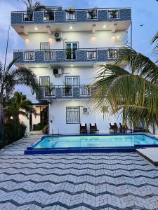 a house with a swimming pool in front of a building at Blue Diamond Resort in Trincomalee