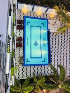 a blue swimming pool on the side of a building at Blue Diamond Resort in Trincomalee
