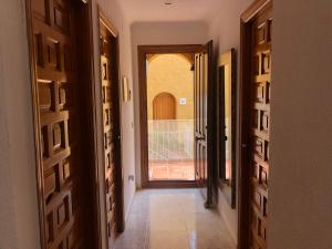 a hallway with a door leading to a balcony at Paraíso in Cumbre del Sol