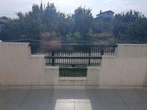 a fence with a view of a body of water at Airport Apartment in Surčin