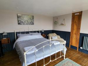 a bedroom with a white bed and a chair at Inner Dowsing Lightship in Rochester
