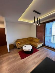 a living room with a couch and a table at Apartament City Warszawa in Warsaw