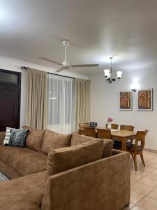 a living room with a couch and a table at 3-bedroom apartment by Mas in Dar es Salaam