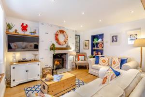 a living room with a couch and a fireplace at Pentreath in Torpoint