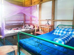 A bed or beds in a room at Simple Cozy Room in Buntumalangka'