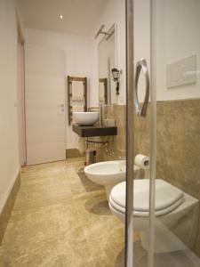 a bathroom with two toilets and a sink and a shower at B&B Virò in Campi Salentina +46 photos