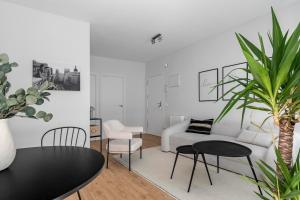 a living room with a couch and a table and chairs at Cozy 2 bedroom apartment with patio in Madrid
