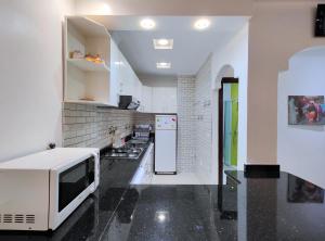 a kitchen with a microwave and a refrigerator at Tangier Center Free Parking in Tangier