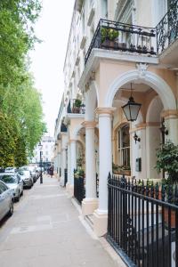 a building with columns and a balcony on a street at Dolphin Hotel in London