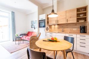 a kitchen and dining room with a table and chairs at Steger-Hüs Wohnung 13 in Rantum