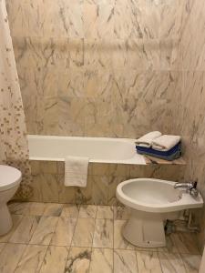 a bathroom with a tub and a toilet and a sink at Large Studio 907T near Monte Carlo Casino Monaco in Monte Carlo