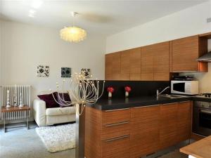 a kitchen with a black counter top and wooden cabinets at Lenno Centrale in Lenno +12 photos