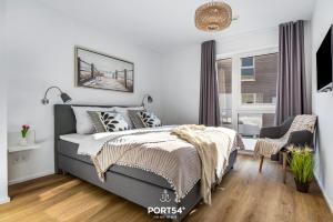 une chambre avec un lit et une chaise dans l'établissement Hafen Loft, à Olpenitz