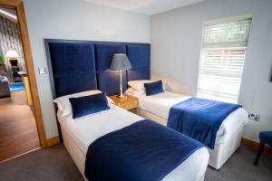 A bed or beds in a room at The Hollies Forest Lodges