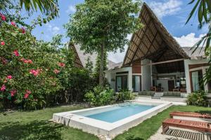 a house with a swimming pool in the yard at SEACLUB Siargao in General Luna