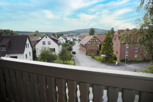 a view from a balcony of a town with houses at DG-Wohnung mit sonnigem Balkon in Marburg an der Lahn