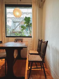 苗栗市的住宿－小仙肉包棟民宿，窗户房间里一张桌子和一把椅子