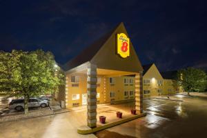 a yellow building with a sign on top of it at Super 8 by Wyndham De Soto in De Soto