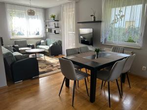 a living room with a dining room table and chairs at Quiet enclave near the airport in Wrocław