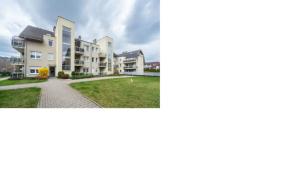 two pictures of a apartment complex with a lawn at Quiet enclave near the airport in Wrocław