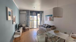 a living room with a table and a couch at Beach House Carmen 2 in Monte Gordo