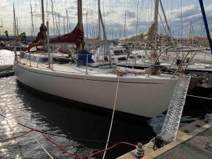 a white sail boat docked in a harbor at Tanimara in Leucate