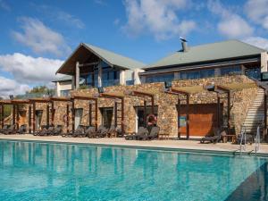 a resort with a swimming pool in front of a building at Pullman Bunker Bay Resort Margaret River in Dunsborough