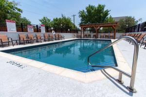 a swimming pool with a hand rail in a hotel at Hampton Inn & Suites Denton in Denton