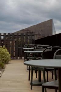 a row of tables and chairs in front of a building at LIVINGWAY Roco in Liverpool