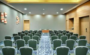 a conference room with green chairs and a table at Hilton Garden Inn Tabuk in Tabuk +29 photos