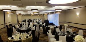 a banquet room with tables and chairs and tablesktop at Embassy Suites by Hilton Seattle North Lynnwood in Lynnwood