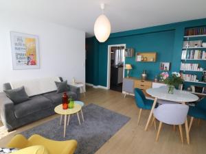 a living room with a couch and a table and chairs at Appartement Aurillac, 2 pièces, 2 personnes - FR-1-742-389 in Aurillac