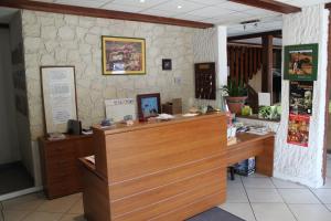 a restaurant with a counter and a stone wall at Au Feu de Bois in Amou