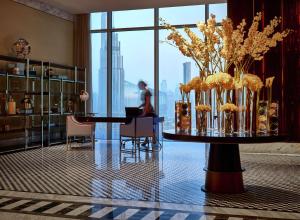 a room with a table with a vase of flowers at Waldorf Astoria Dubai International Financial Centre in Dubai