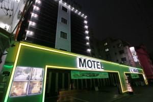 una tienda con un cartel que dice motel frente a un edificio en Motel Lamant en Bucheon