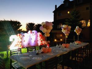 a long table with balloons and a number two sign at Sofra E Shpatit in Elbasan