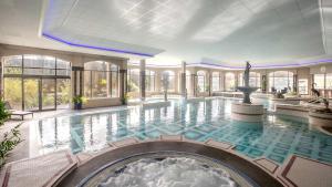a swimming pool with a fountain in the middle of a building at The Glenview Hotel & Leisure Club in Newtown Mount Kennedy