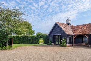 a black church with a tower on top of it at Elegant luxurious cottage - The Dove House in Ipswich