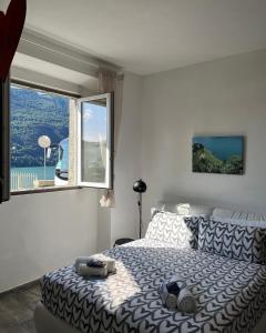 a bedroom with a bed and a large window at Casa Giulietta Junior20 with private parking in Blevio