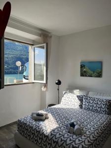 a bedroom with a large bed with a large window at Casa Giulietta Junior20 with private parking in Blevio