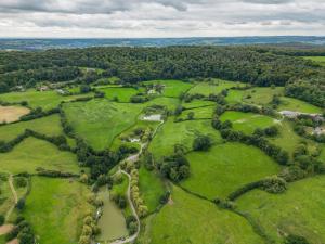 an aerial view of a park with trees and grass at Owls Nest Barn in Harescombe