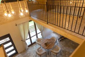 a wooden table and chairs in a room with a staircase at Satul de vacanta Cuibul Lupilor in Ciucea +28 photos