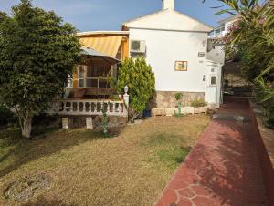 a house with a yard next to a building at Villa Carmen in Torrox Costa