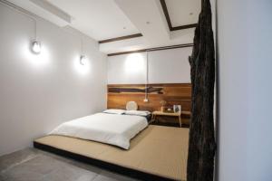 a bedroom with a large bed and a desk at Arbor's house in Chiang Mai